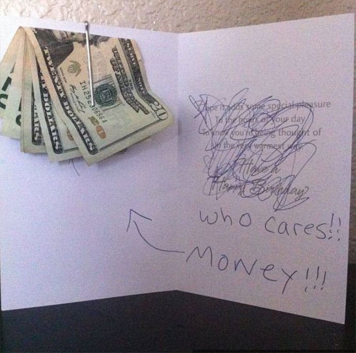 A birthday card with scribbled words, showing a humorous emphasis on the money gift inside.