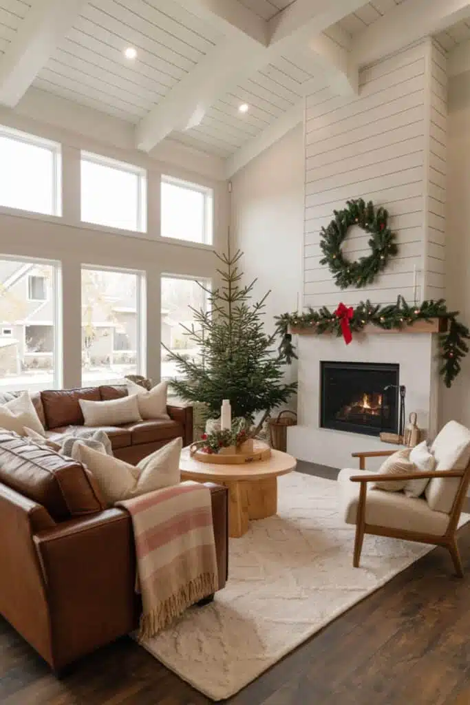  A cozy living room for Christmas with a brown couch and a fireplace