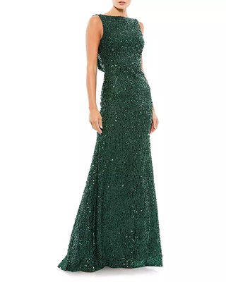 A model wearing a green beaded evening gown