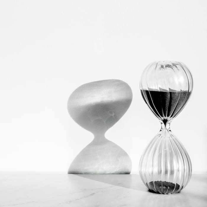 A black and white image of an hourglass