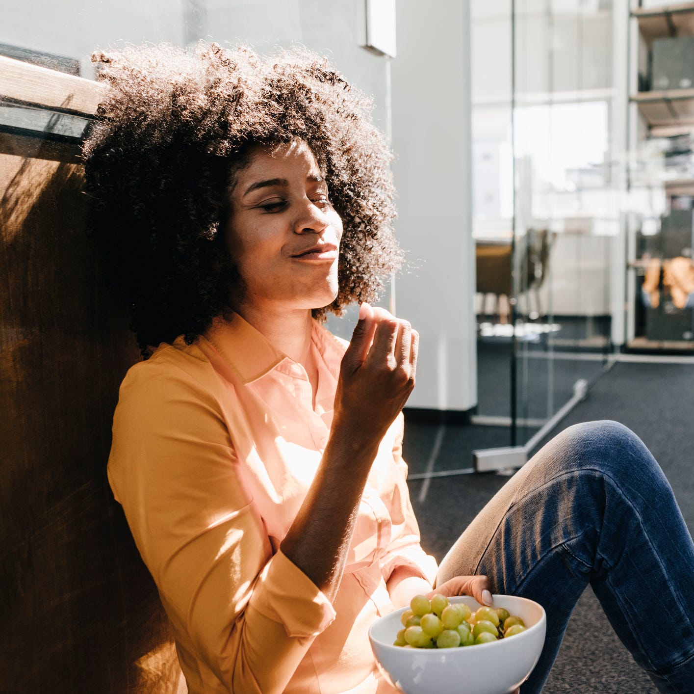 young woman eating grapes