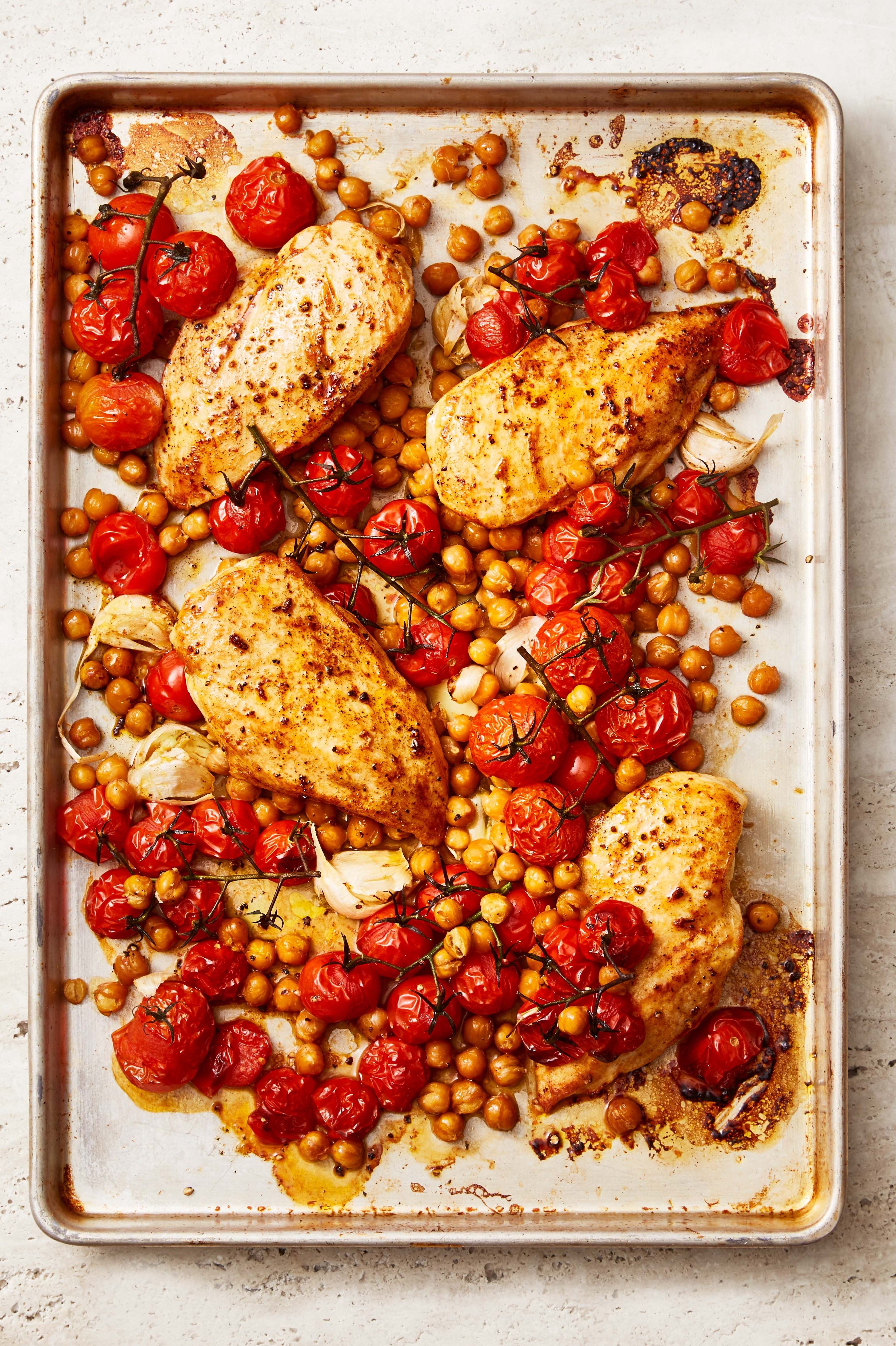 paprika chicken with crispy chickpeas and tomatoes on a sheet pan