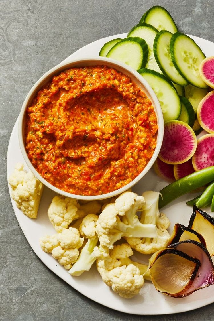 roasted pepper dip with a side of cauliflower, red onions, radishes and green beans for dipping