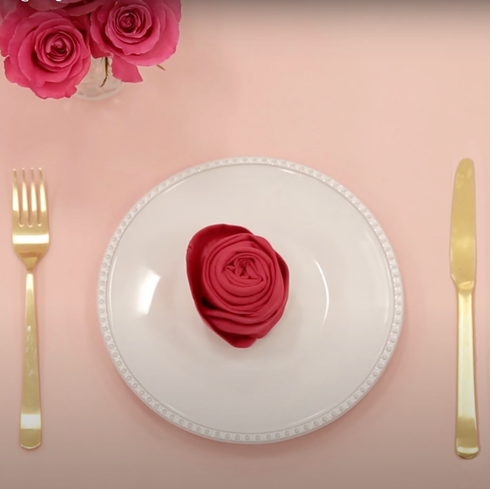 rose napkin on plate