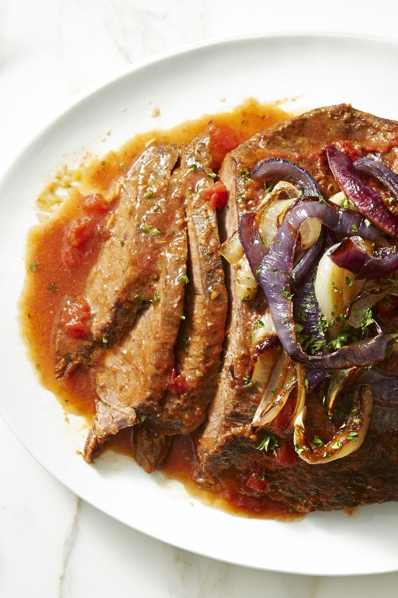 slow cooker brisket with cooked red onions on top