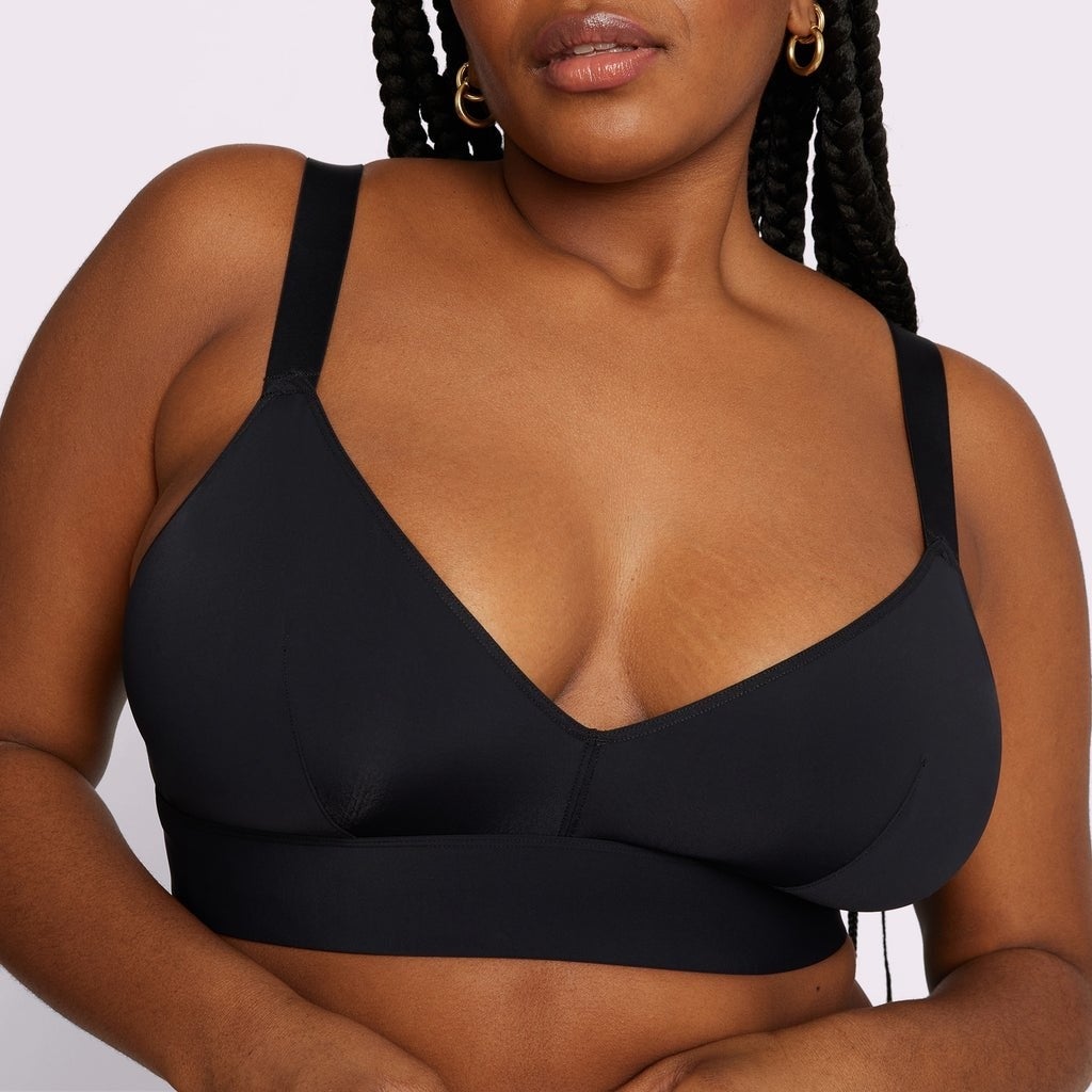 a model wearing the black triangle bralette