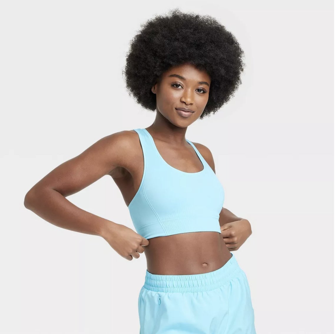 model in an aqua blue sports bra