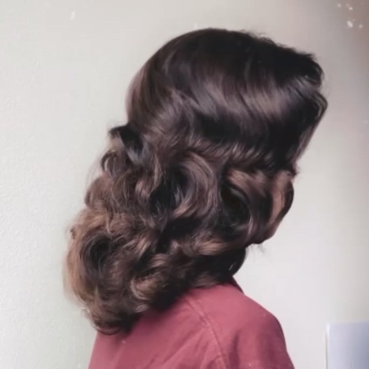 The same reviewer with the finished look, with shiny vintagey brushed-out curls