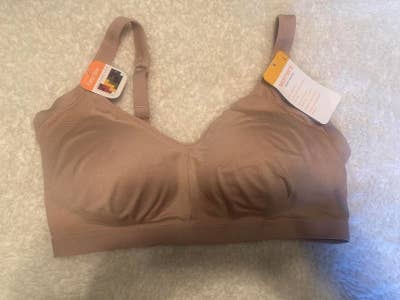 A light-brown bra with tags attached, displayed on a white surface