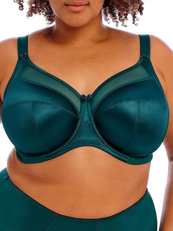 Person modeling a green underwire bra with sheer panels