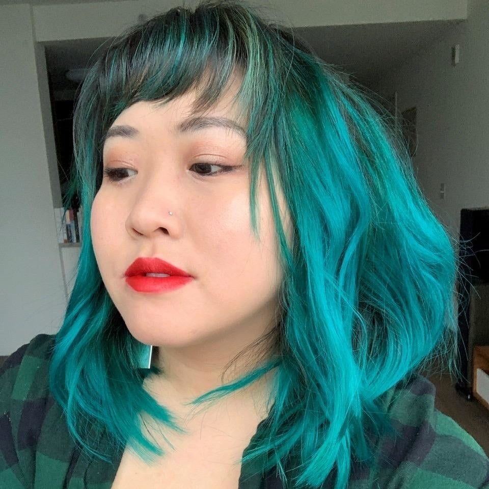 reviewer with bright teal hair that's shoulder length 