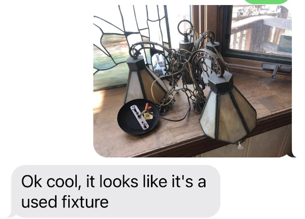 Used light fixture on a windowsill with text message stating, "Ok cool, it looks like it's a used fixture."