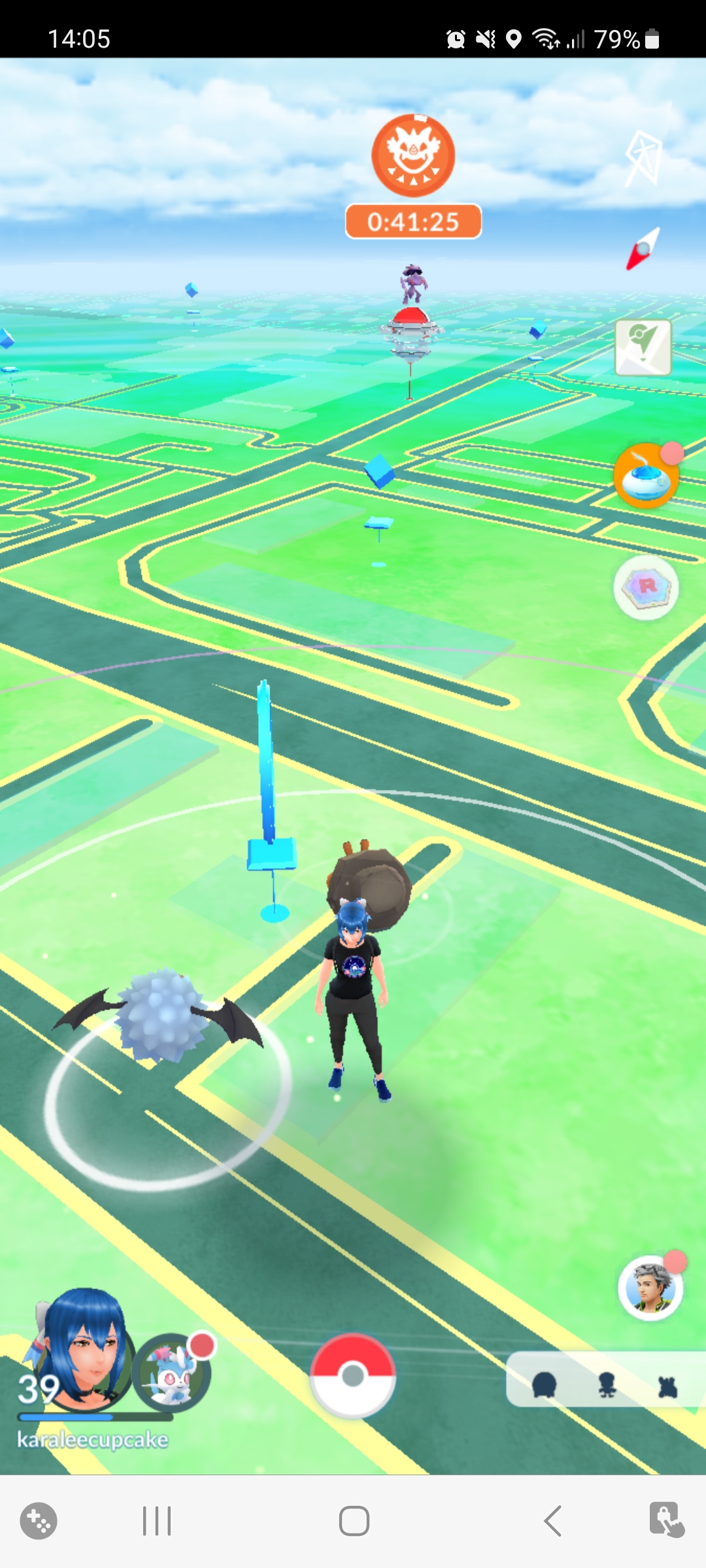 A pokestop with two pokemon by it and a pokemon gym in the distance in pokemon go, which is the ninth cozy game on this list. 