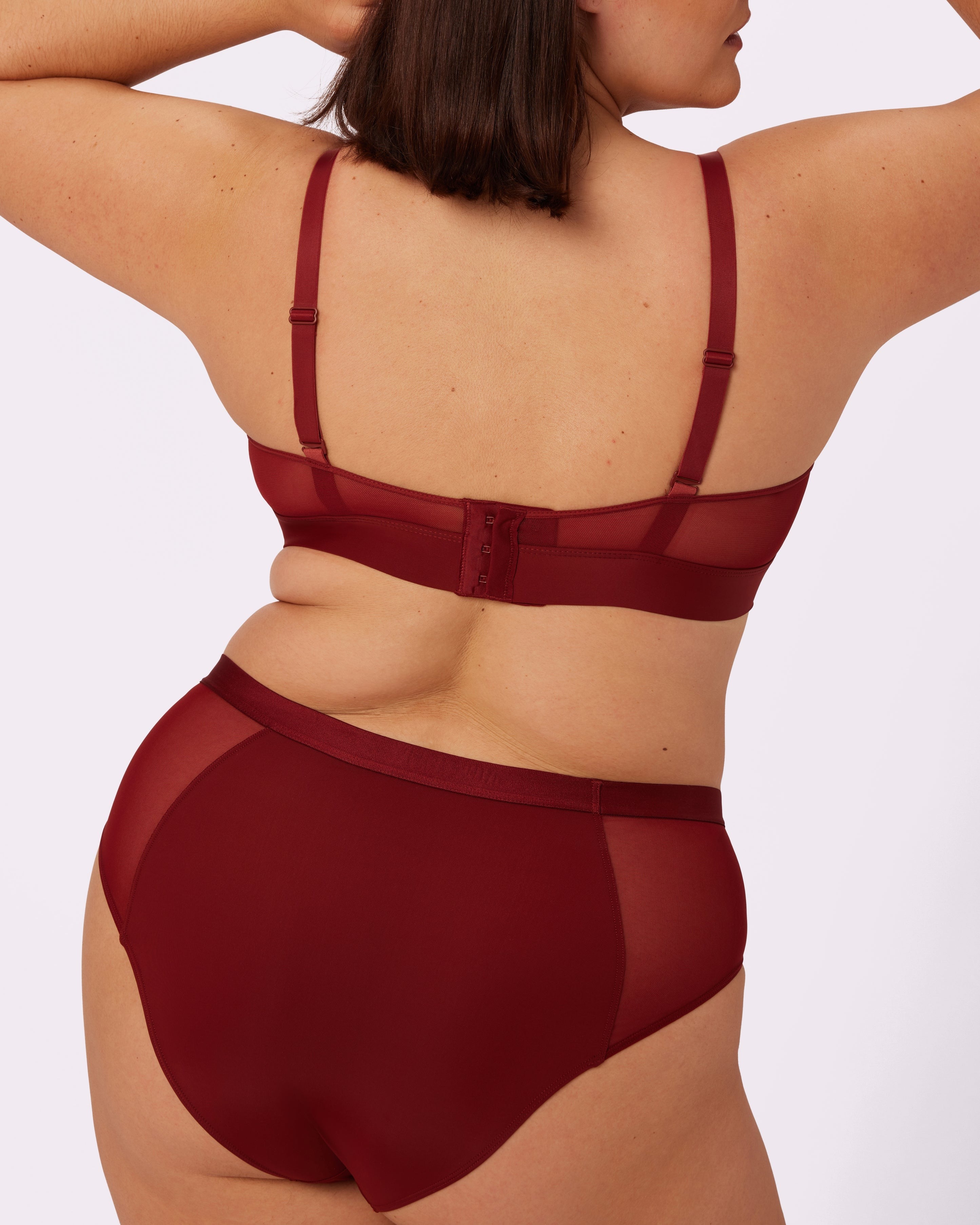 A person wearing a matching set of lingerie, showcasing the fit and design from the back view