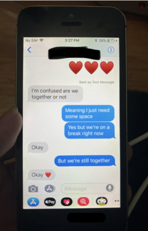 Text conversation showing a person asking, "I'm confused, are we together or not," with a response stating, "Meaning I just need some space. Yes, but we’re on a break right now."