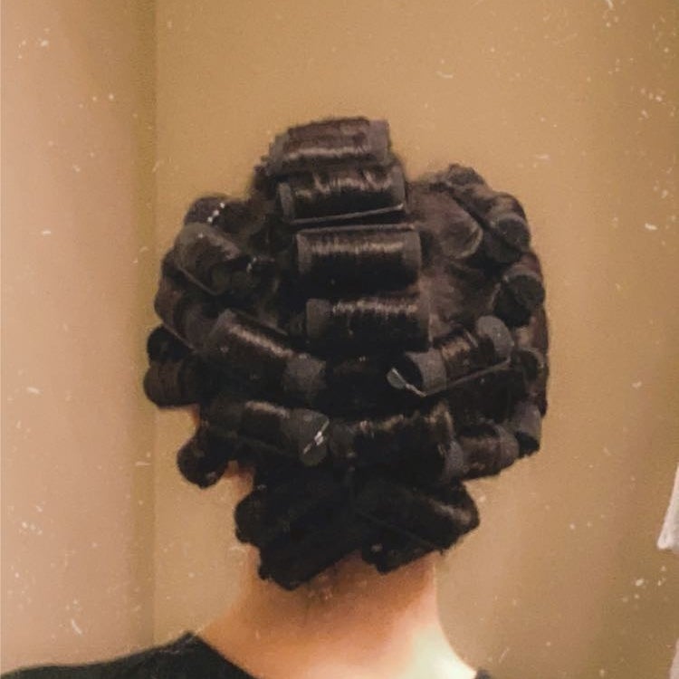 A reviewer with the curlers in their hair