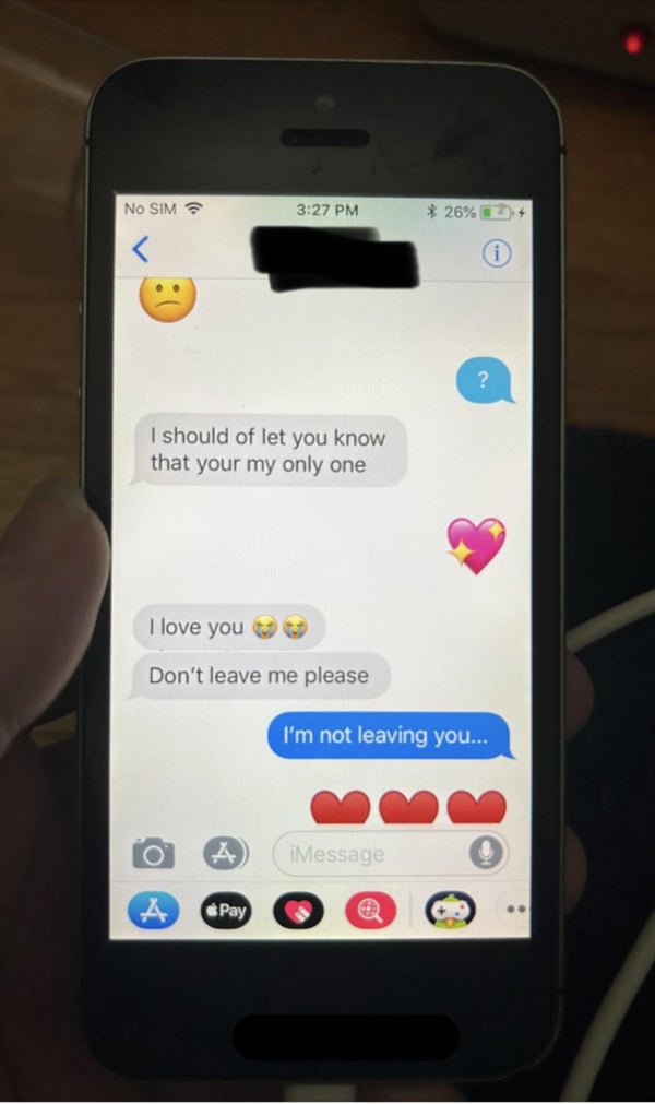 A smartphone displaying a conversation. Messages include an apology for not informing earlier, expressing love, asking not to leave, and reassurance of not leaving