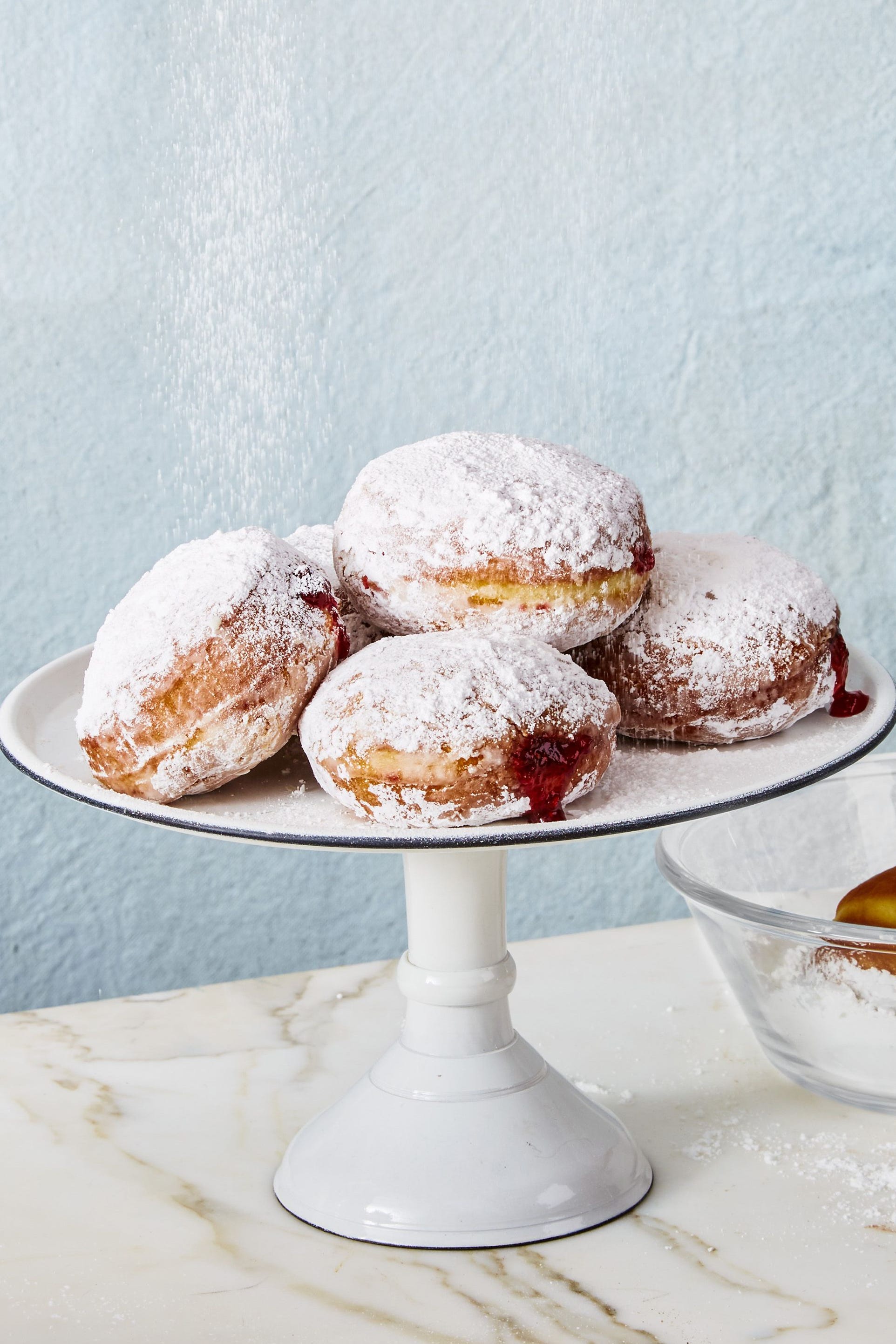 sufganiyot jelly donuts on a white cake stand