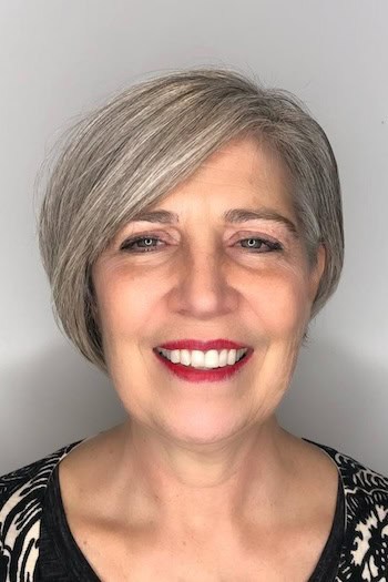 Short Side-Swept Bob hairstyle on a woman in her 60s with gray hair.