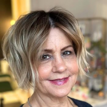 Textured Wavy Bob hairstyle on a woman in her 60s with brown hair and blonde highlights.