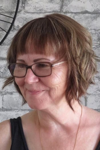 Choppy Bob with Bangs hairstyle on a woman in her 60s with brown hair.