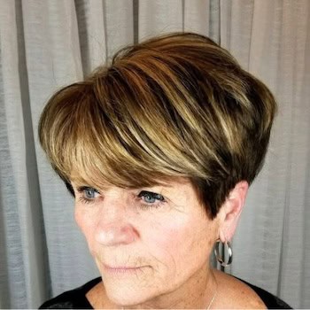Short Pixie with Volume hairstyle on a woman in her 60s with highlighted brown hair.