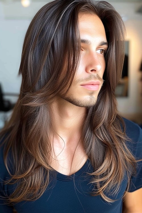 Long layers hairstyle on young man.