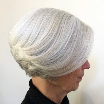 Stacked Bob Hairstyle on an older woman with silver hair, side view.
