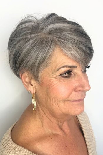 Pixie With Side-Swept Bangs Hairstyle on an older woman with gray hair, side view.