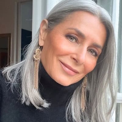 Shoulder-Length Silver Lob (Long Bob) Hairstyle on a smiling older woman with straight gray hair.