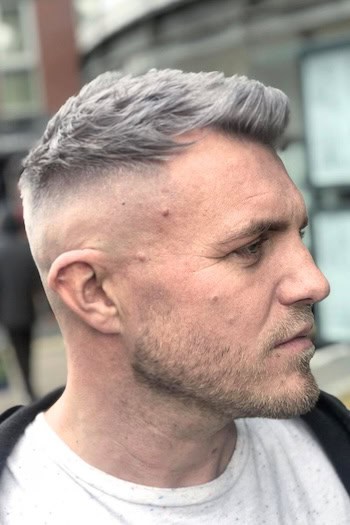 Short Pompadour with Fade Men's Haircut, side view.