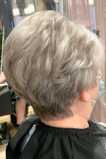 Voluminous Silver Pixie with Stacked Back Haircut, back view.