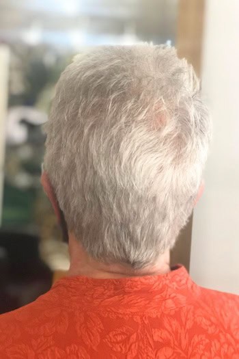 Short Silver Pixie with Tapered Back Haircut, back view.