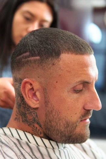 Buzz Cut with Mid Fade and Line Design Men's Haircut, side view.