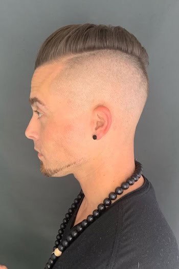 Shaved Sides with Slicked Back Top Men's Haircut, side view.