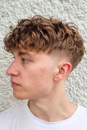 Curly Top with Low Fade Men's Haircut, side view.