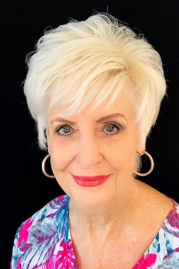 Textured Pixie with Bangs hairstyle on a woman in her 60s with blonde hair.