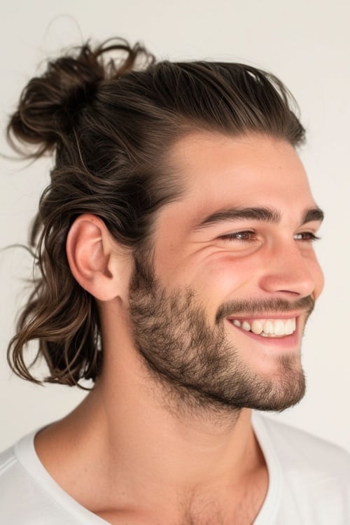 Half up half down hairstyle on smiling handsome man.