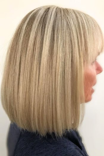 Straight Long Bob Hairstyle on an older woman with shoulder-length blonde hair, side view.