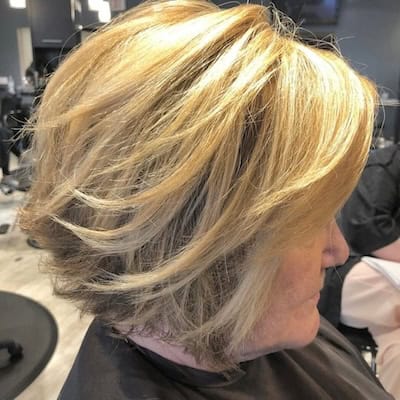 Textured Layered Bob Hairstyle on an older woman with layered blonde hair.
