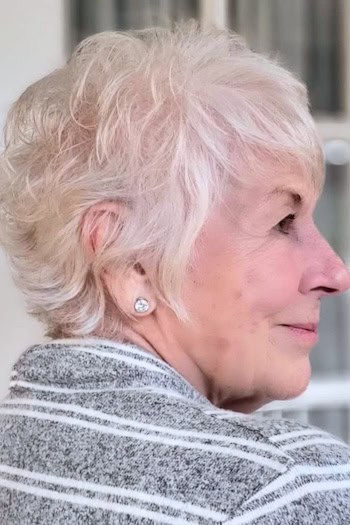 Tousled Platinum Pixie with Bangs Haircut, side view.
