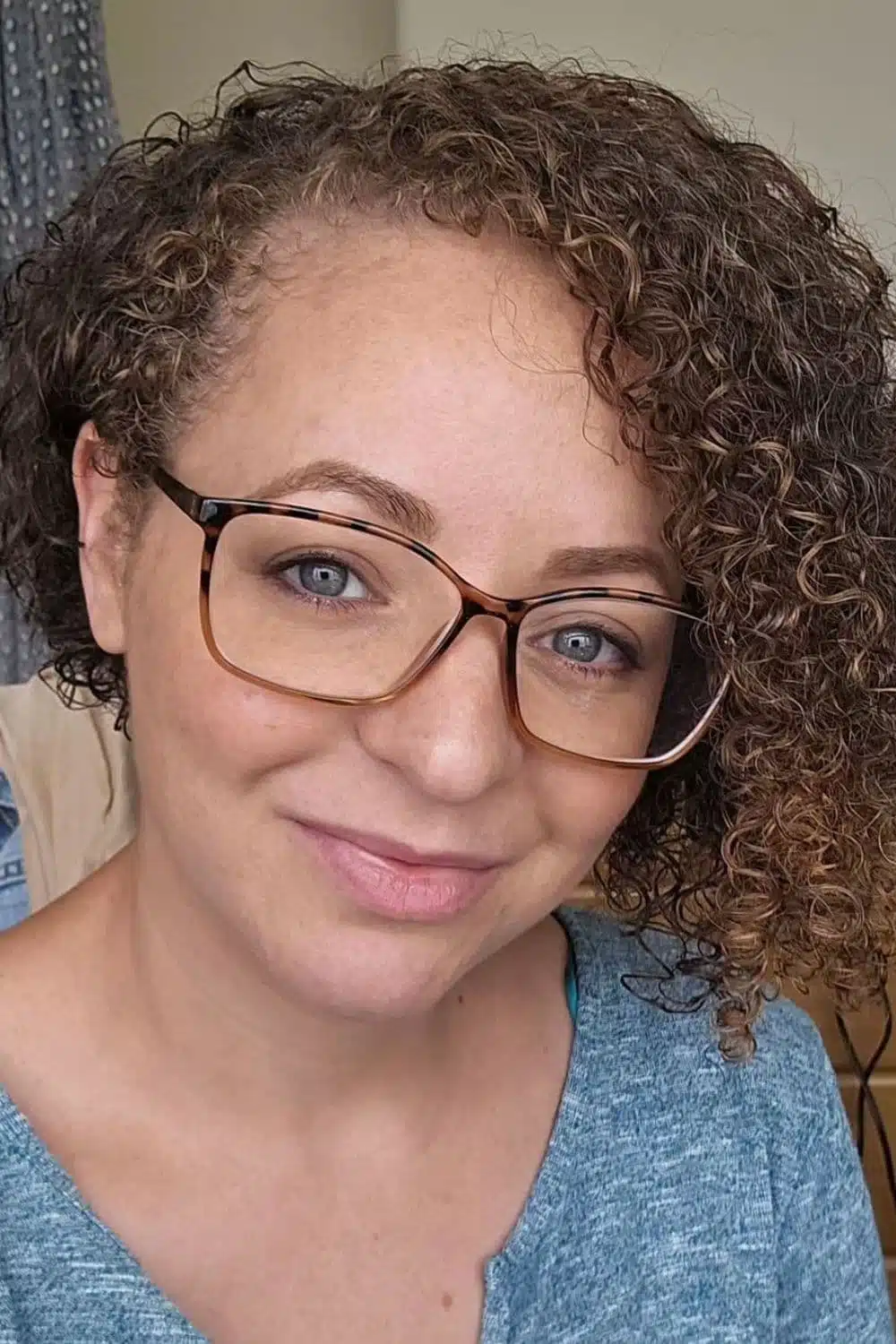 A woman with a brown asymmetrical bob cut.