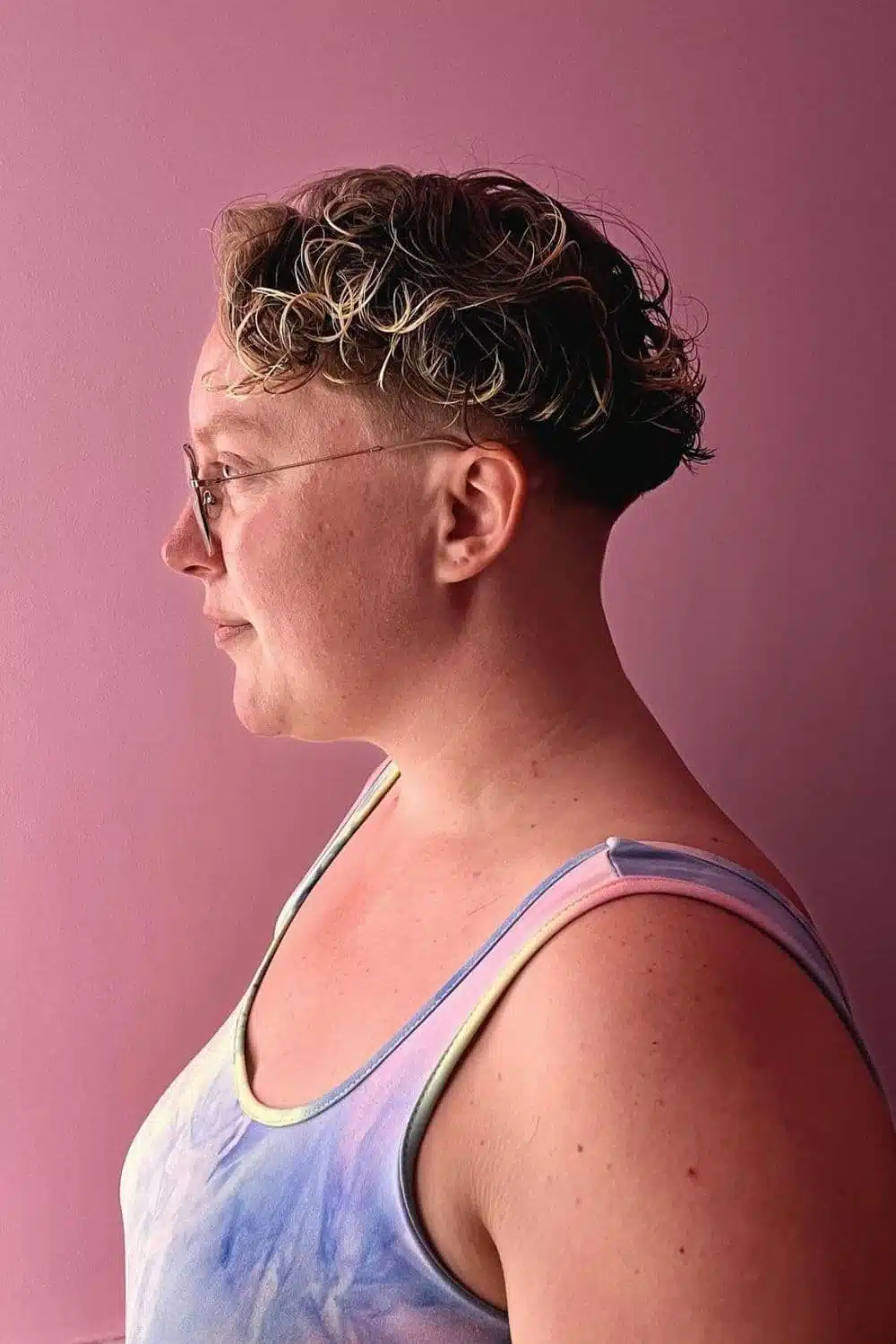 A woman with a curly mushroom cut.