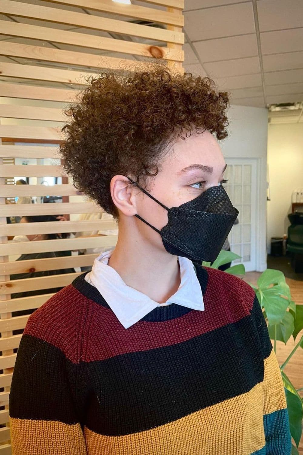A woman with a red curly wedge cut.