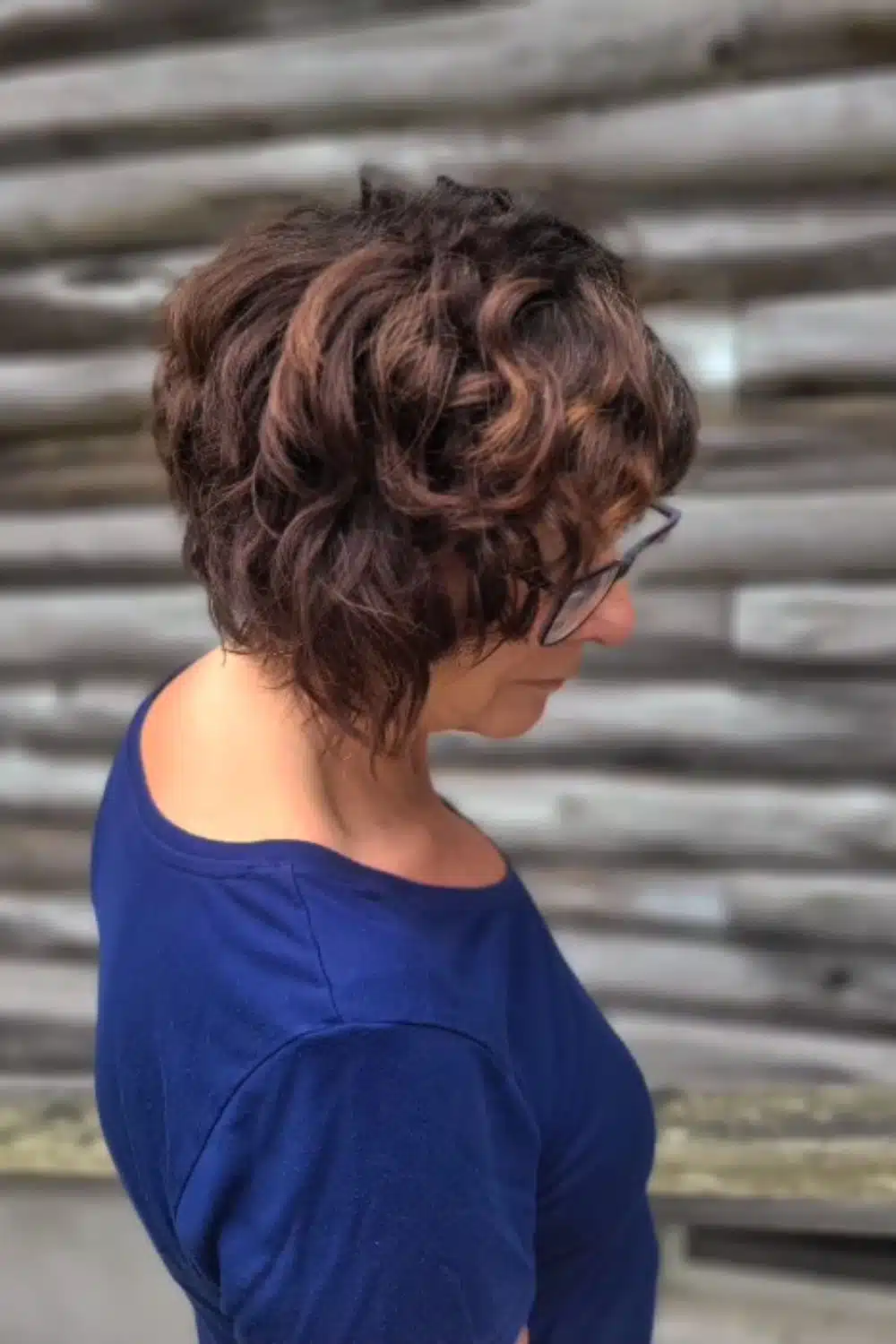 A woman with a brown layered chin-length bob cut.