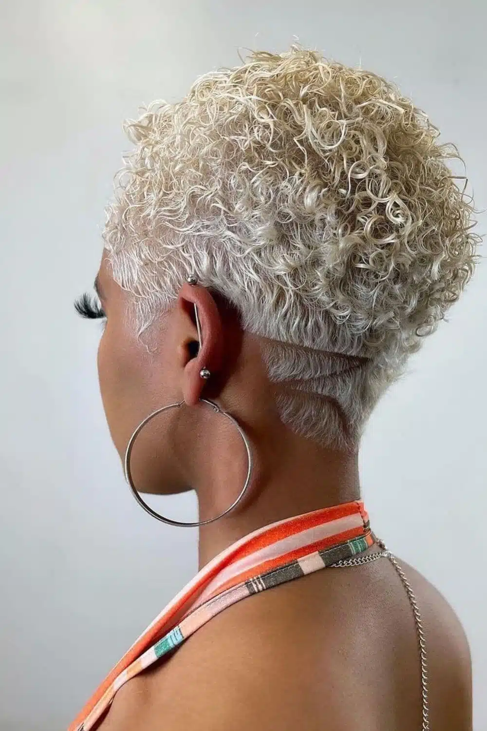 A woman with a blonde tapered teeny weeny Afro.