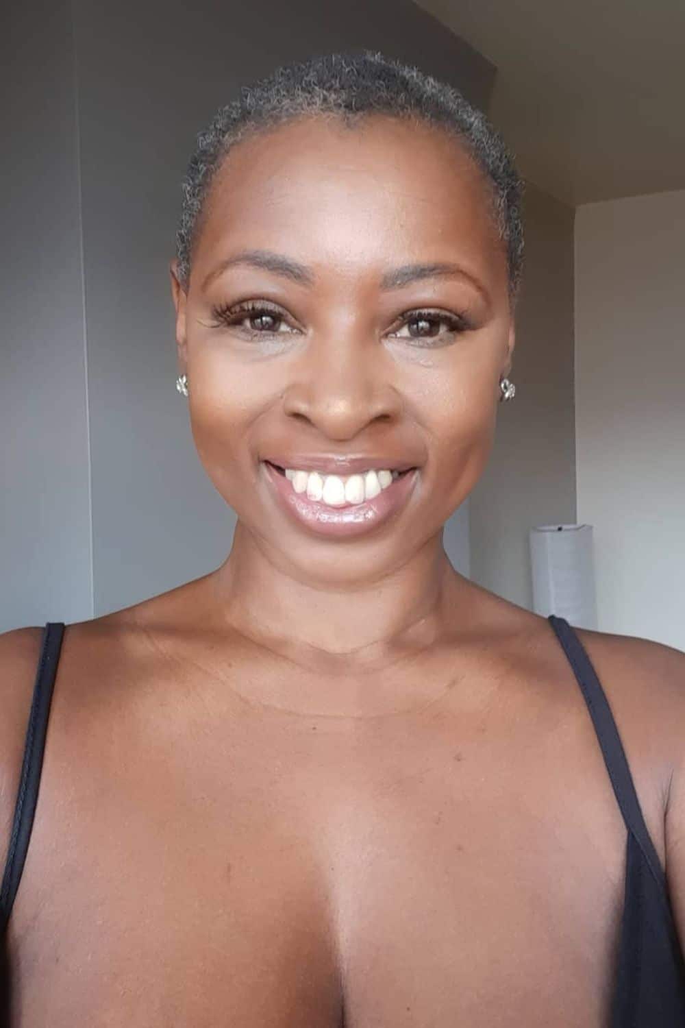 A black woman with a gray teeny weeny Afro.