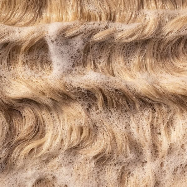 Sudsy wavy blonde hair.