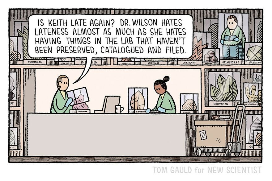 Two lab workers sit at a desk. One asks if someone named Keith is late again, adding that Dr. Wilson dislikes lateness and disorganized lab items equally. The lab shelves in the background are filled with boxes and labeled items.