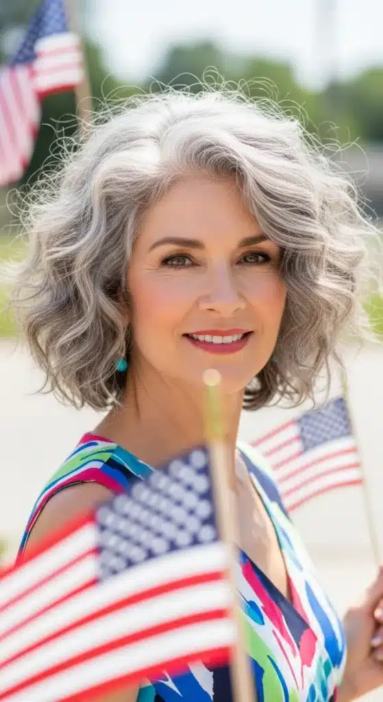 Curly shoulder-length layers hairstyle for women over 60 styled for 4th of July 2025, showing soft natural curls in a festive outdoor setting.
